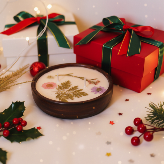 Decorative soap with pressed flowers, surrounded by Christmas-themed elements on a white surface.