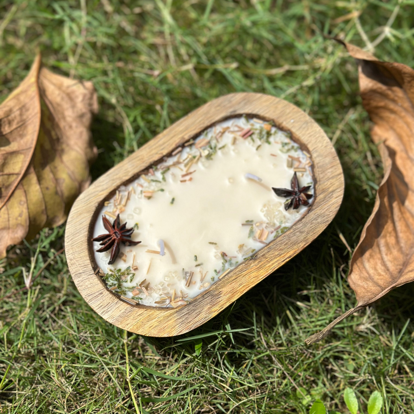 Wooden bowl with a white substance on grass