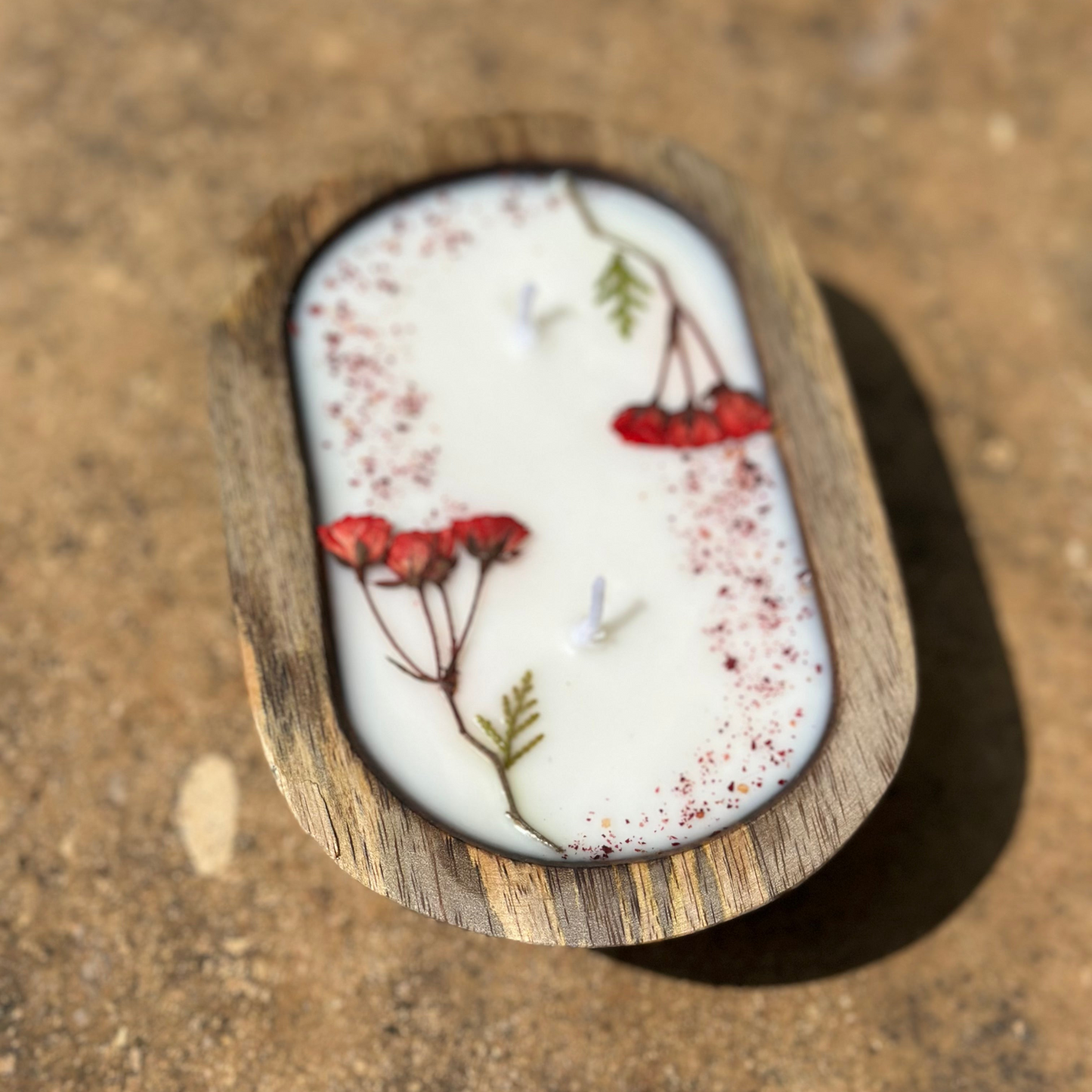 Decorative stone with floral design on a textured surface