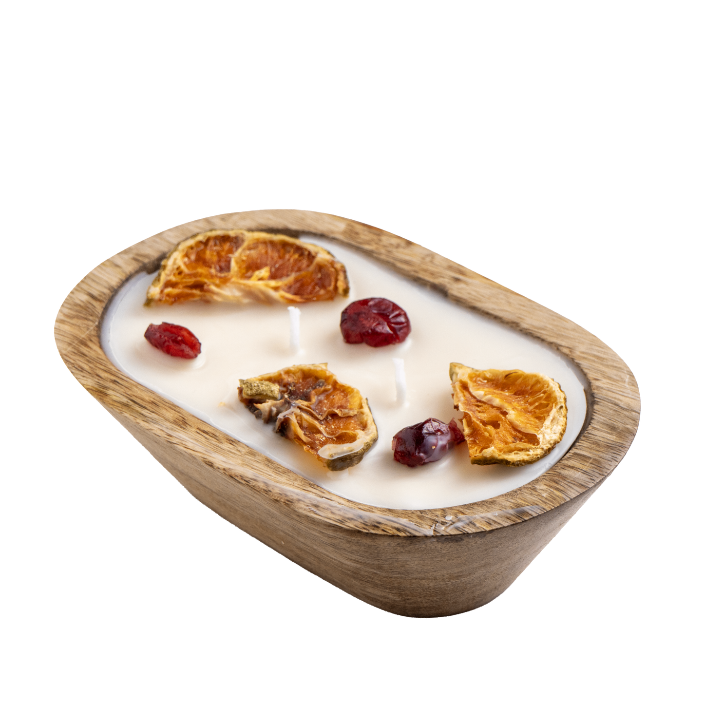 A wooden bowl candle with dried fruits against a white background