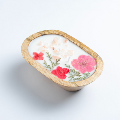 Candle in a wooden holder with floral design on a white background