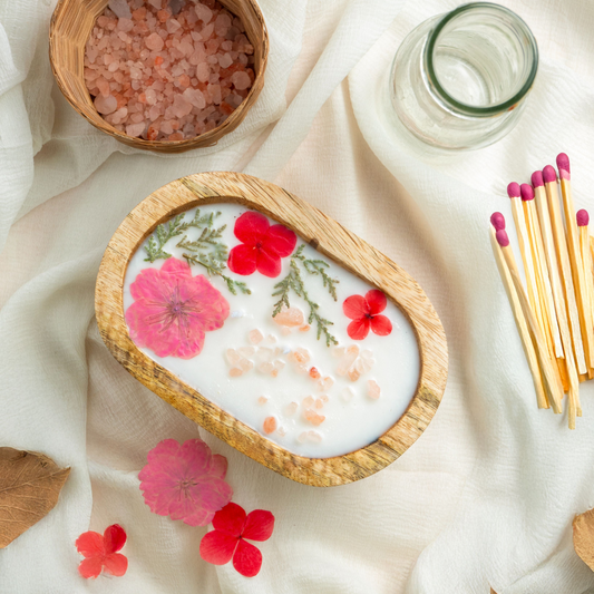 Decorative bowl with flowers and salt on a light fabric background