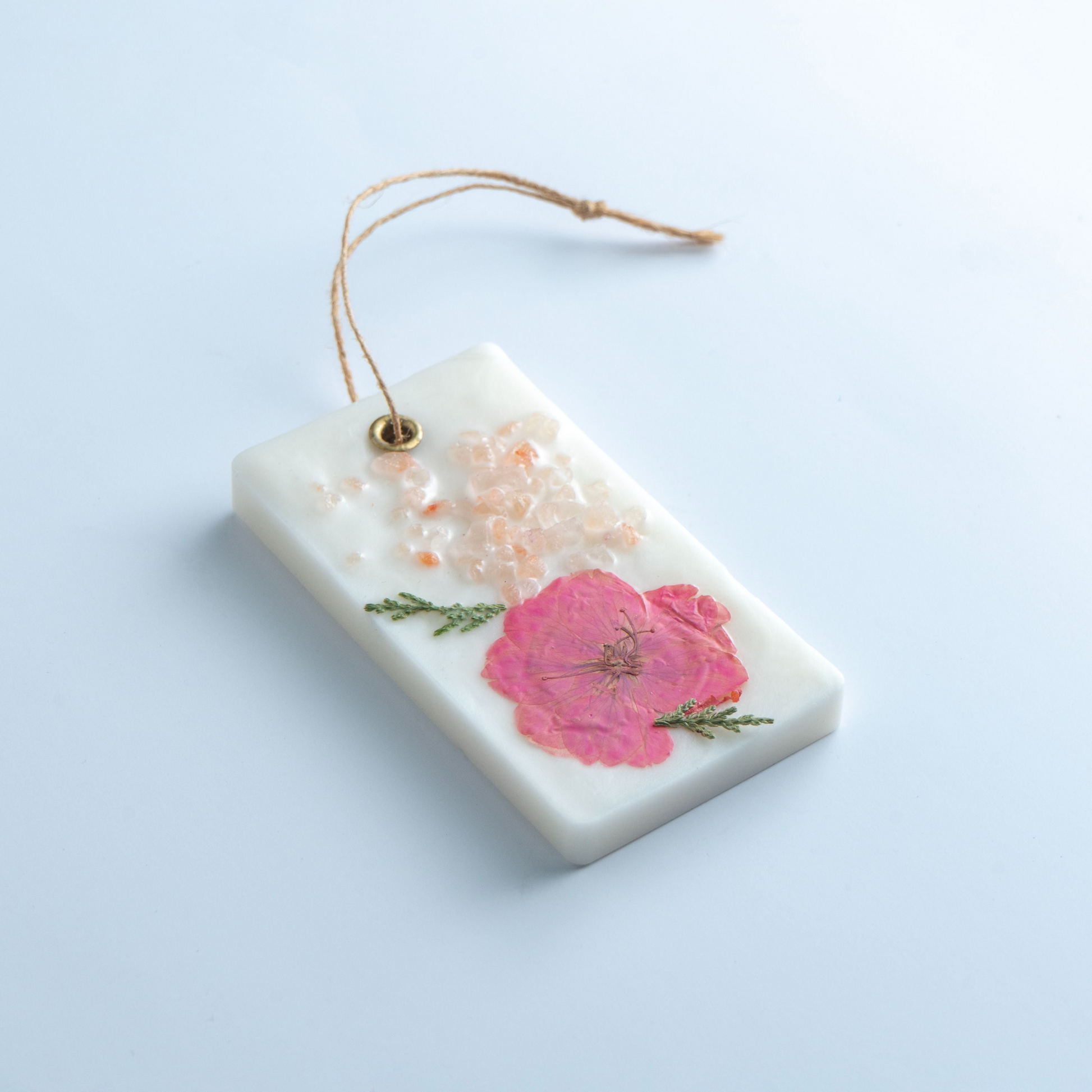 Decorative tag with floral design on a light blue background