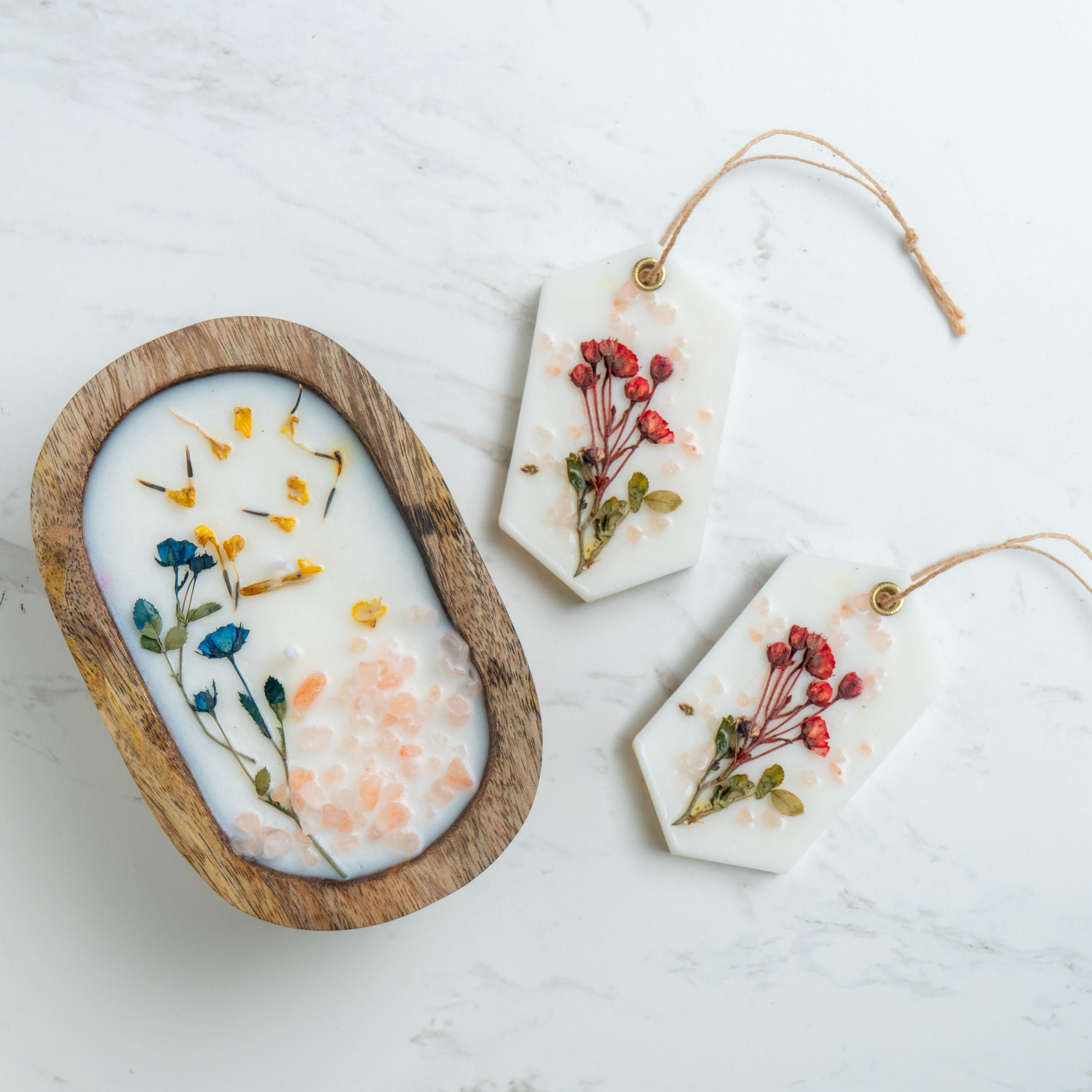 Decorative items with pressed flowers on a light background