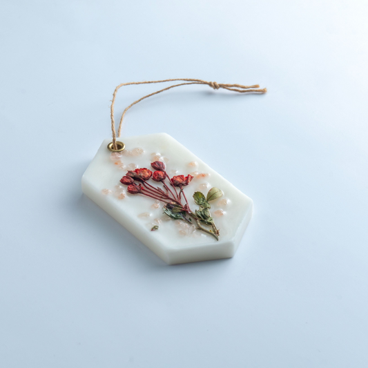 Decorative soap with dried flowers on a light blue background