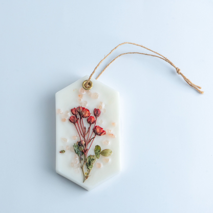 Hexagonal white ornament with floral design on a light blue background