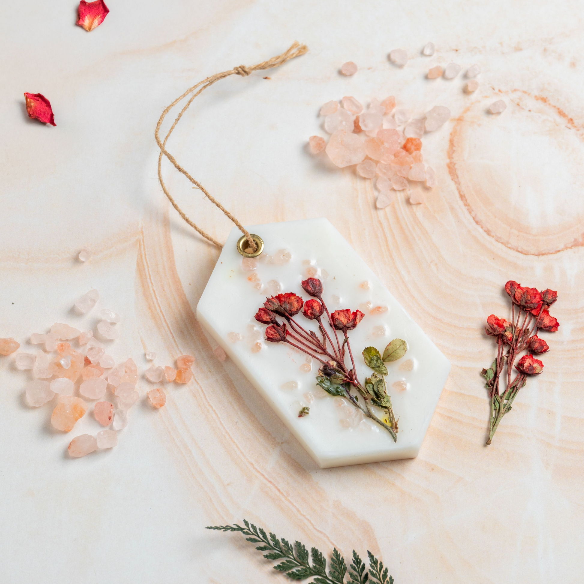 Decorative soap with pressed flowers on a wooden surface